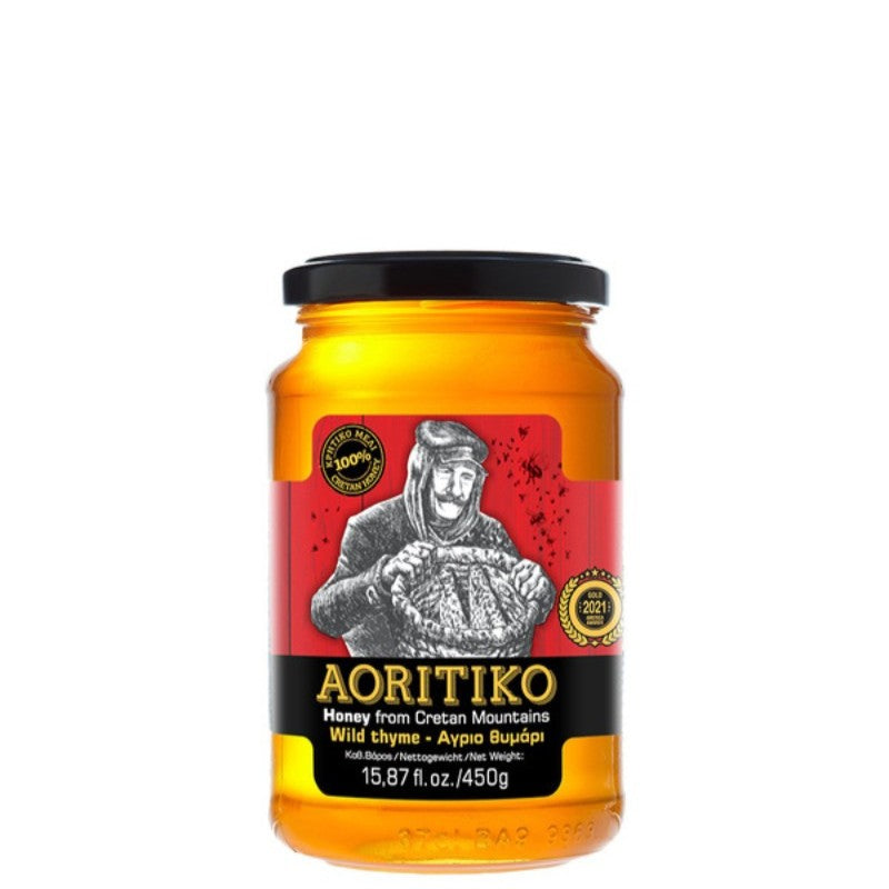 Glazen pot Aoritiko tijmhoning van Fragiadakis, 450 gram, gevuld met Kretenzische honing uit bergregio’s. Rijk, kruidig aroma van tijm en wilde bloemen, 100% natuurlijk en glutenvrij – ideaal voor ontbijt, thee of als gezonde zoetmaker.